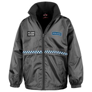 The front view of the 'Children's Police Waterproof Jacket' displays a zippered closure, a microfleece-lined collar for warmth, and elasticated cuffs. It includes a 'POLICE' patch on the right chest, with 'PC 999 NITON' printed beside it, and a blue and w